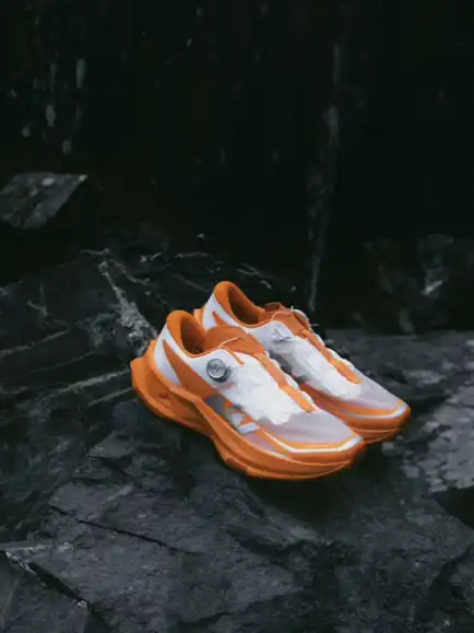 Orange and white athletic shoes.