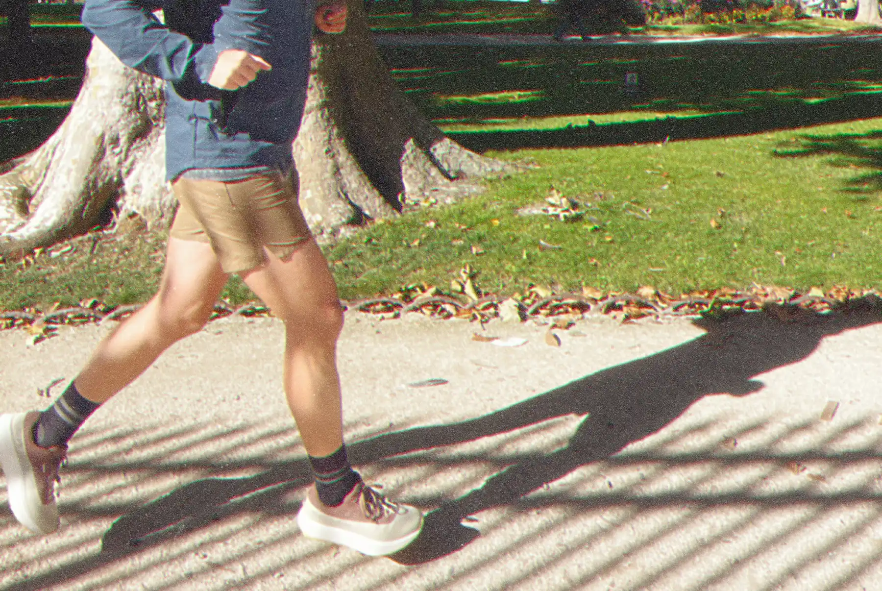 Person jogging in park setting.