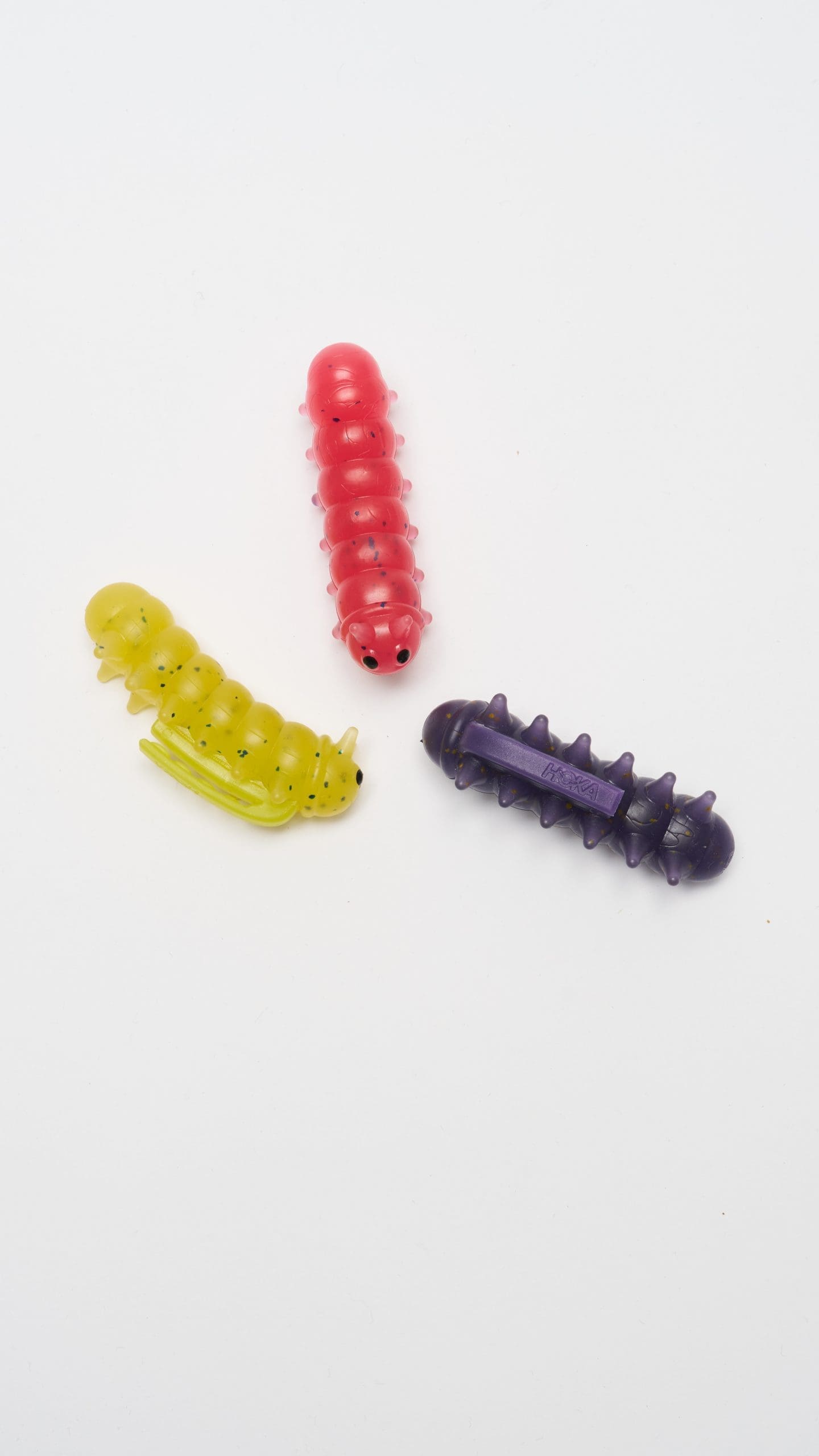 Colorful gummy worm charms on white