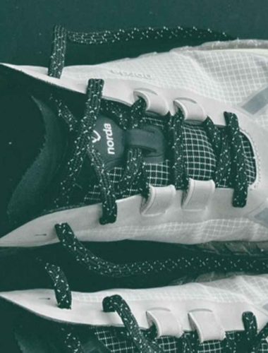 White athletic shoes with black laces - Norda 001a