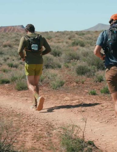 Runners on a desert trail. Luxury Running Brands.