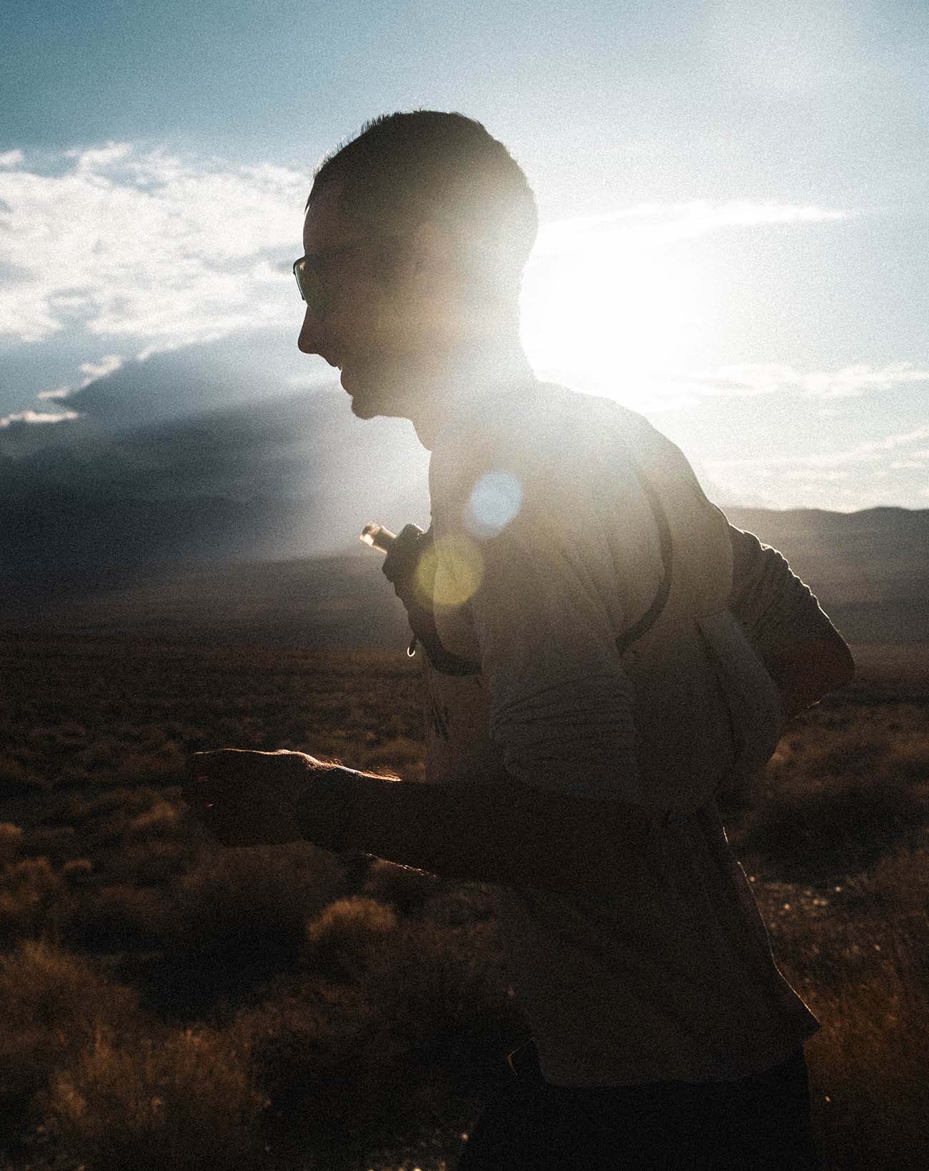 A runner trail running at sunrise