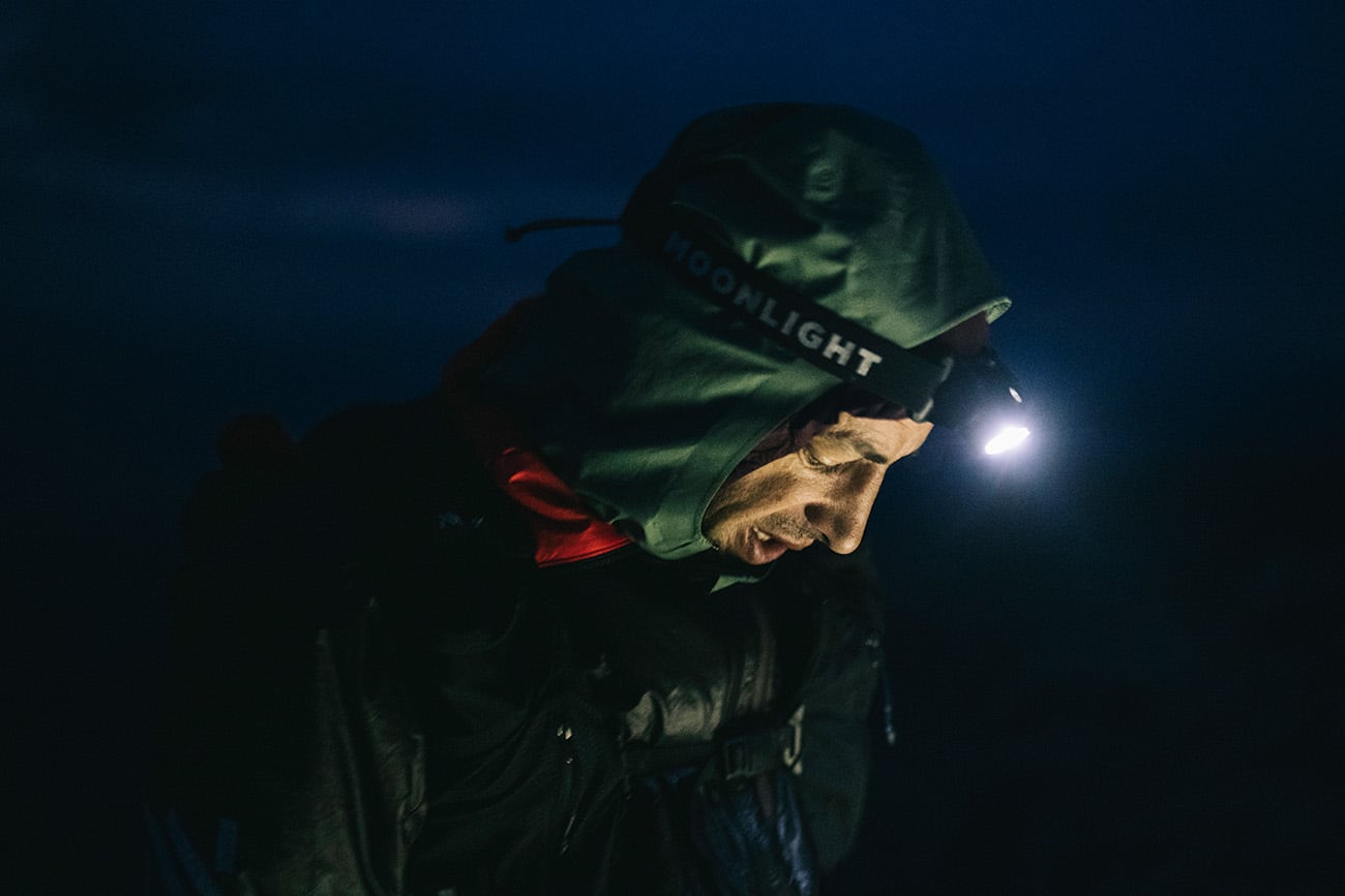 Runner wearing headlight preparing to run in the night