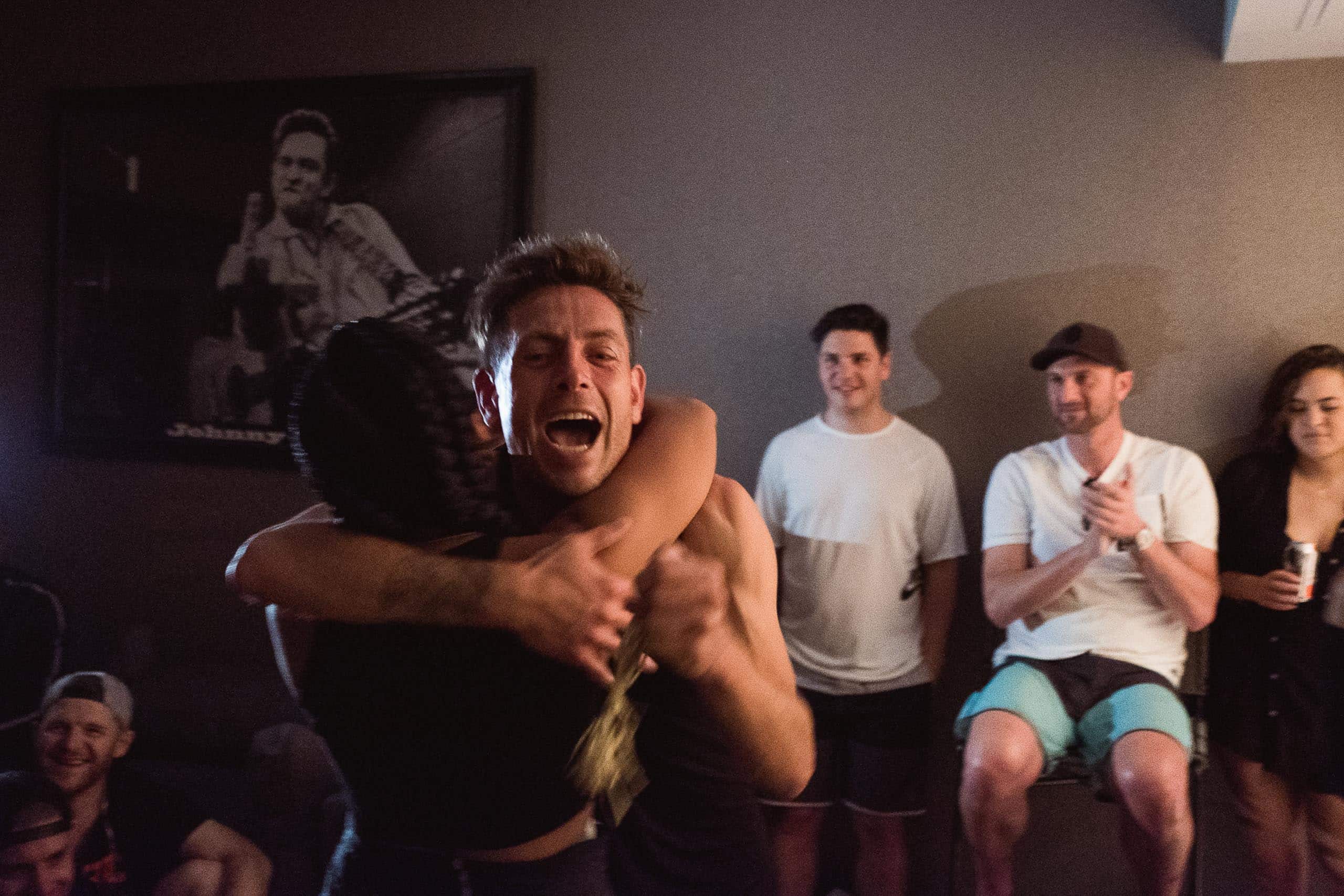 Two people hugging and celebrating after the Speed Project