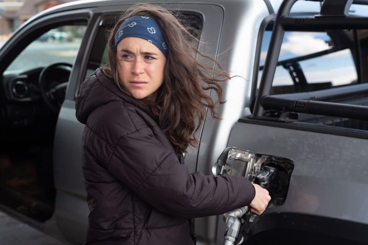 Molly Seidel fueling vehicle at gas station.