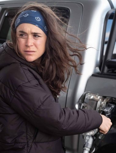 Molly Seidel fueling vehicle at gas station.
