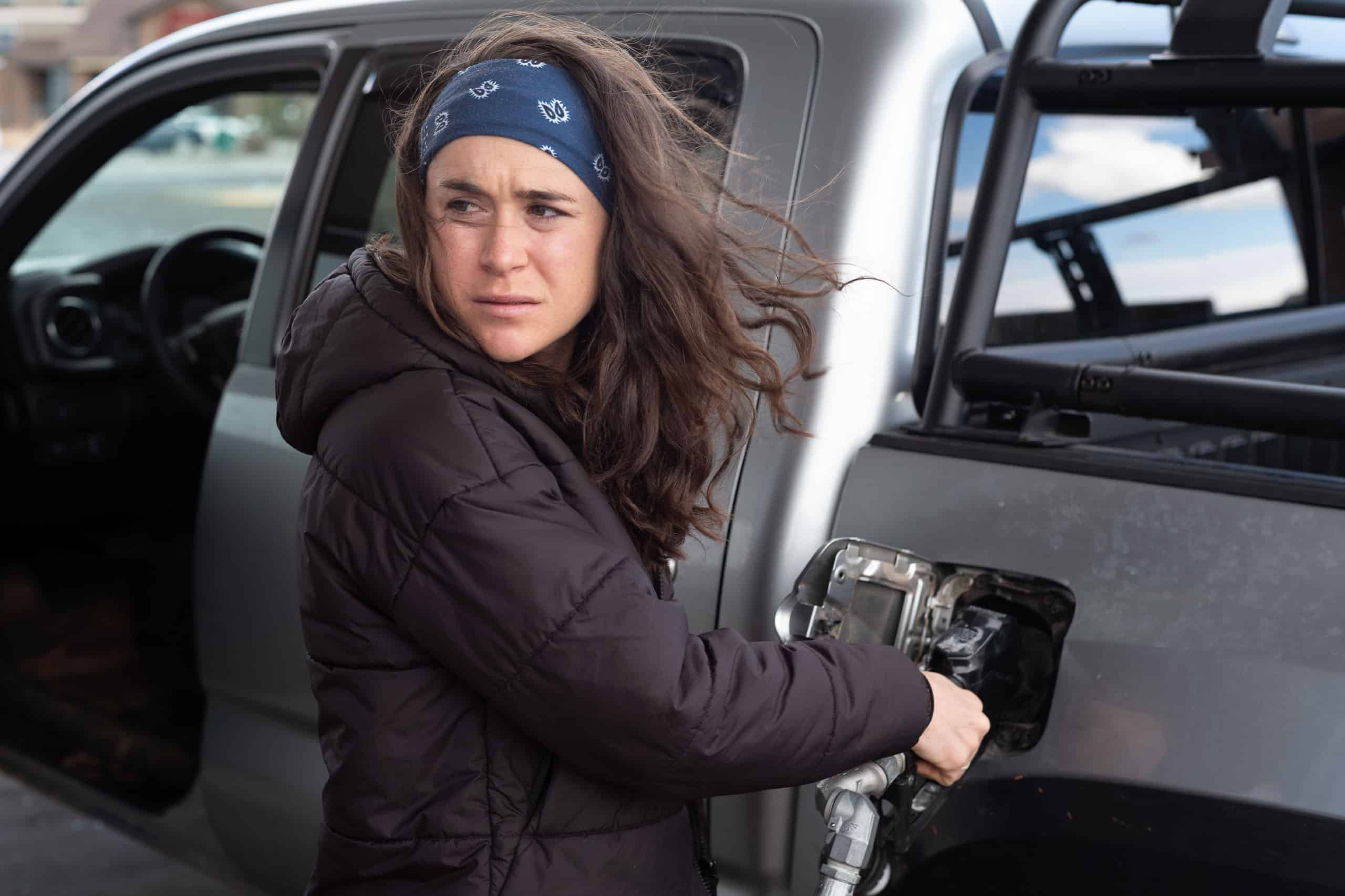 Molly Seidel fueling vehicle at gas station.